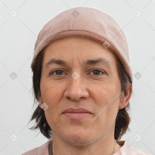 Joyful white adult female with medium  brown hair and brown eyes