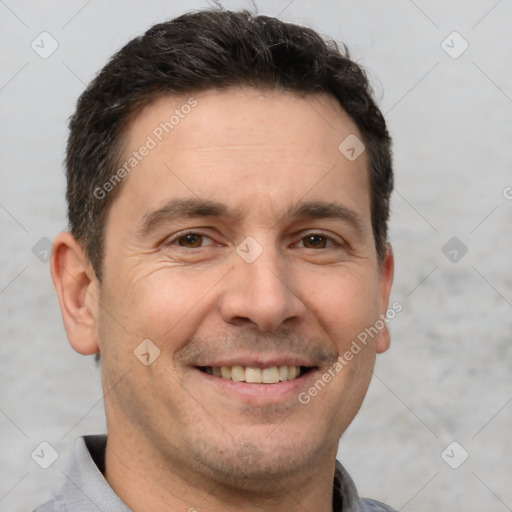 Joyful white adult male with short  brown hair and brown eyes