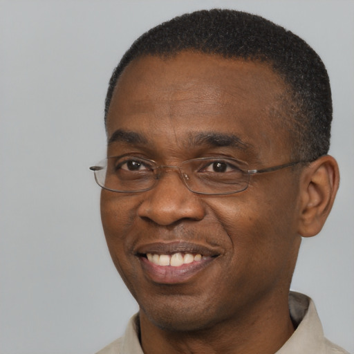 Joyful black adult male with short  brown hair and brown eyes