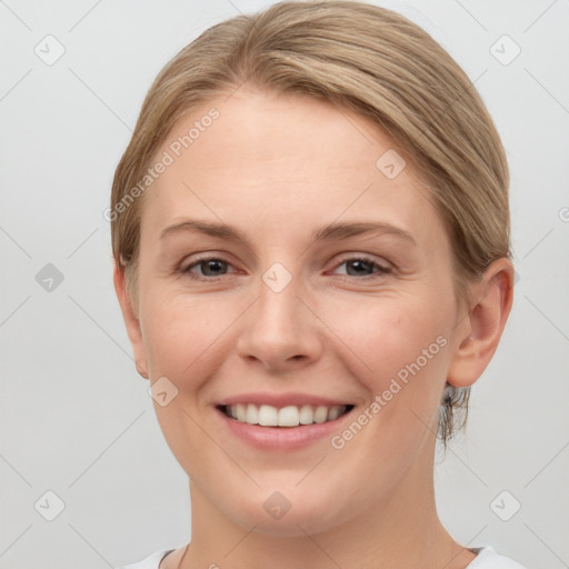 Joyful white young-adult female with short  brown hair and grey eyes