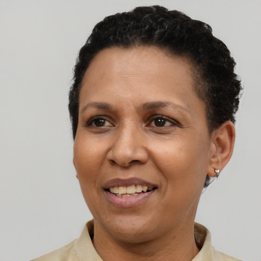 Joyful latino adult female with short  black hair and brown eyes