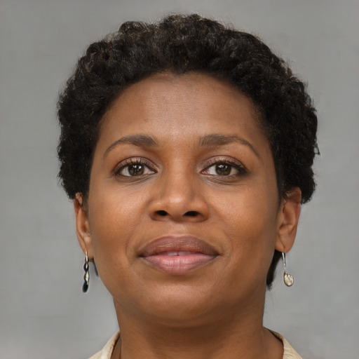 Joyful black adult female with short  brown hair and brown eyes