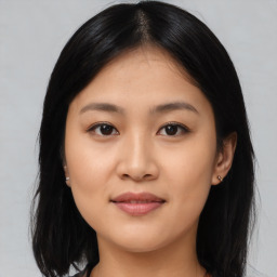 Joyful asian young-adult female with medium  black hair and brown eyes