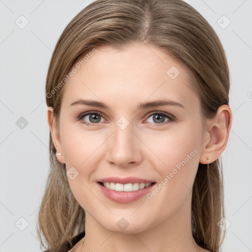 Joyful white young-adult female with long  brown hair and grey eyes