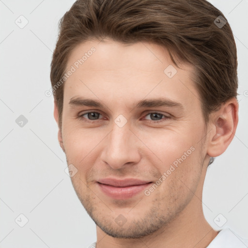 Joyful white young-adult male with short  brown hair and grey eyes