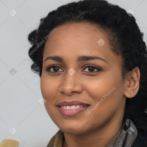 Joyful black young-adult female with long  black hair and brown eyes