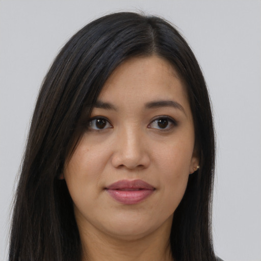 Joyful latino young-adult female with long  brown hair and brown eyes