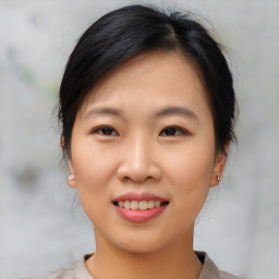 Joyful asian young-adult female with medium  black hair and brown eyes