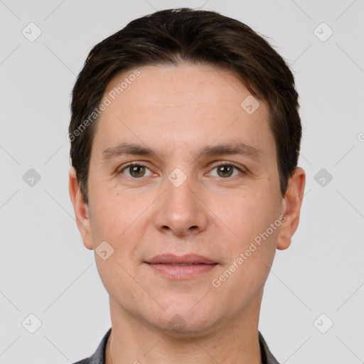 Joyful white young-adult male with short  brown hair and grey eyes