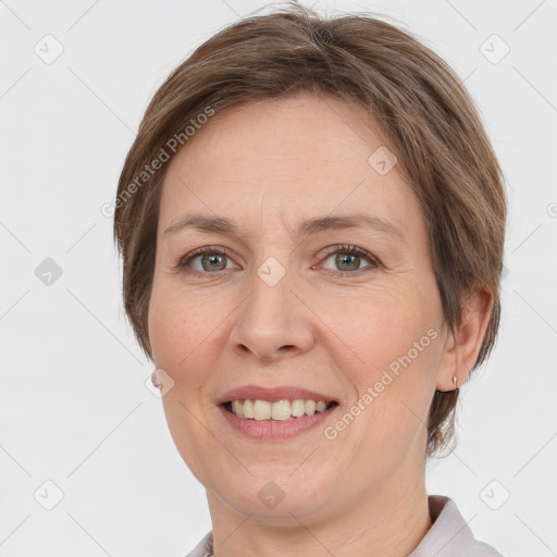 Joyful white adult female with short  brown hair and grey eyes