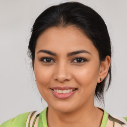 Joyful latino young-adult female with medium  brown hair and brown eyes