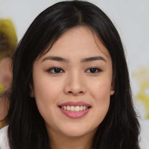Joyful asian young-adult female with long  black hair and brown eyes