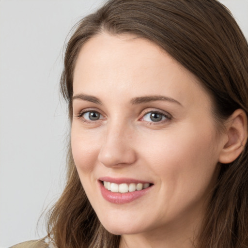 Joyful white young-adult female with long  brown hair and grey eyes