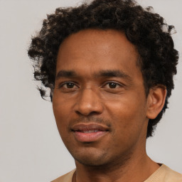 Joyful black adult male with short  black hair and brown eyes