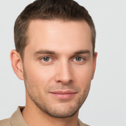 Joyful white young-adult male with short  brown hair and grey eyes