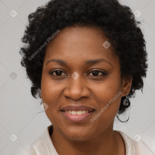 Joyful black adult female with short  brown hair and brown eyes