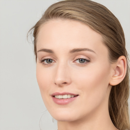 Joyful white young-adult female with long  brown hair and blue eyes