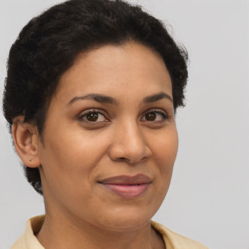 Joyful latino adult female with short  brown hair and brown eyes