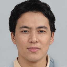 Joyful asian young-adult male with short  black hair and brown eyes