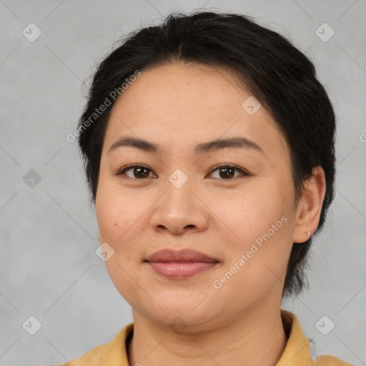 Joyful asian adult female with medium  brown hair and brown eyes