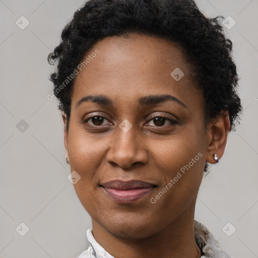 Joyful black young-adult female with short  brown hair and brown eyes