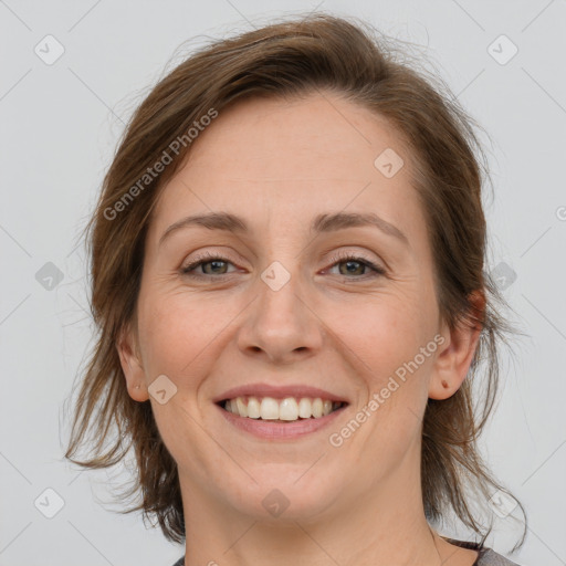 Joyful white adult female with medium  brown hair and blue eyes