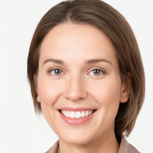 Joyful white young-adult female with medium  brown hair and grey eyes