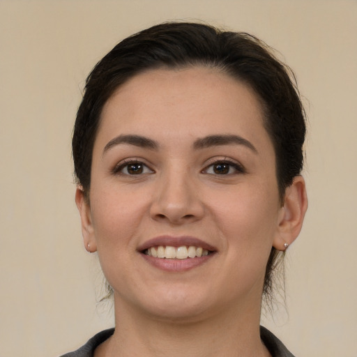 Joyful white young-adult female with medium  brown hair and brown eyes