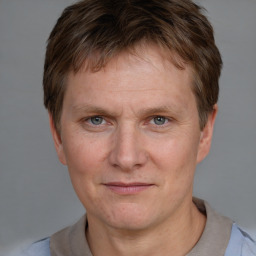 Joyful white adult male with short  brown hair and grey eyes