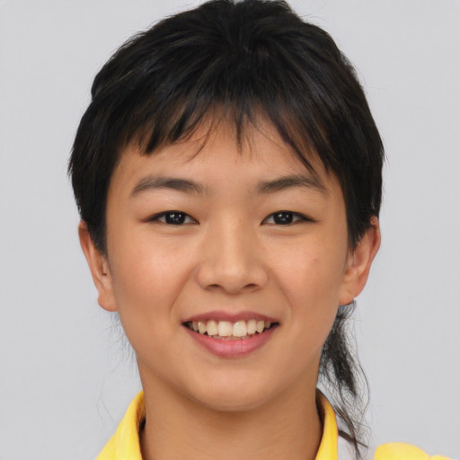 Joyful asian young-adult female with short  brown hair and brown eyes