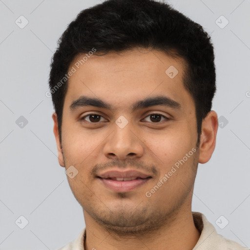 Joyful latino young-adult male with short  black hair and brown eyes