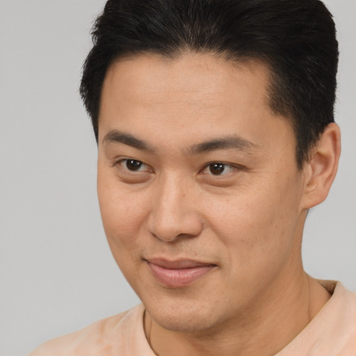 Joyful latino young-adult male with short  brown hair and brown eyes
