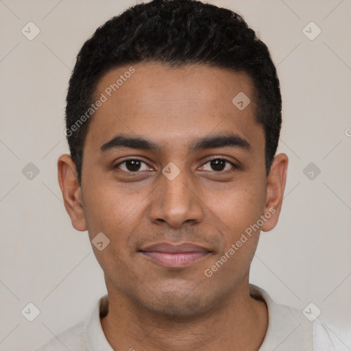 Joyful black young-adult male with short  black hair and brown eyes