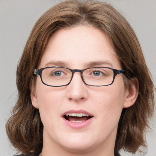 Joyful white young-adult female with medium  brown hair and blue eyes