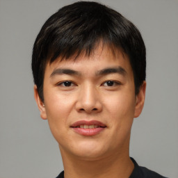 Joyful asian young-adult male with short  brown hair and brown eyes