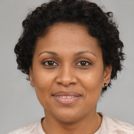 Joyful latino adult female with short  brown hair and brown eyes