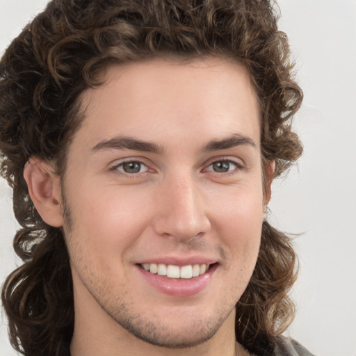 Joyful white young-adult male with medium  brown hair and brown eyes