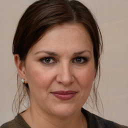 Joyful white adult female with medium  brown hair and brown eyes