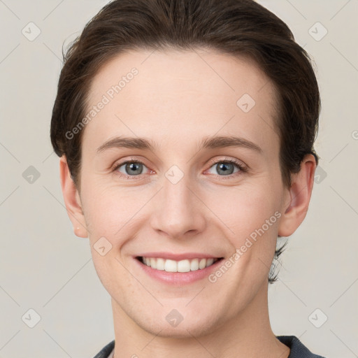 Joyful white young-adult female with short  brown hair and grey eyes