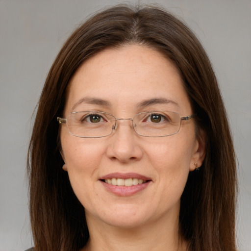 Joyful white adult female with long  brown hair and brown eyes