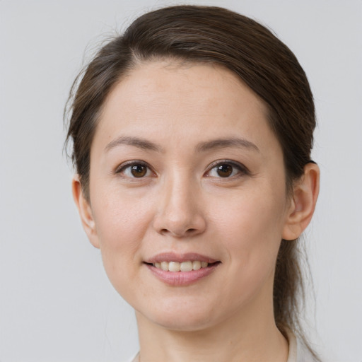 Joyful white young-adult female with medium  brown hair and brown eyes