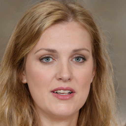 Joyful white young-adult female with long  brown hair and green eyes