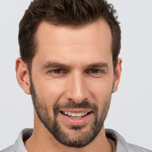 Joyful white young-adult male with short  brown hair and brown eyes