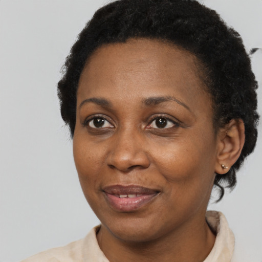 Joyful black adult female with short  brown hair and brown eyes