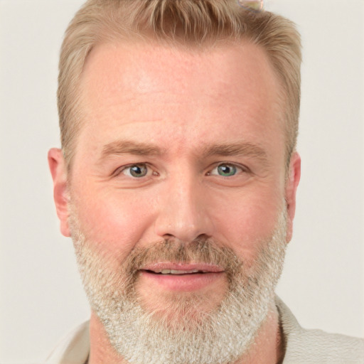 Joyful white adult male with short  brown hair and blue eyes