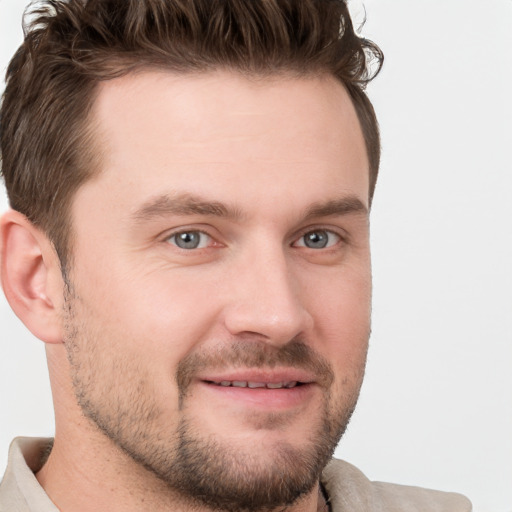 Joyful white young-adult male with short  brown hair and grey eyes