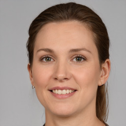 Joyful white young-adult female with medium  brown hair and grey eyes