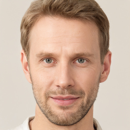 Joyful white adult male with short  brown hair and grey eyes