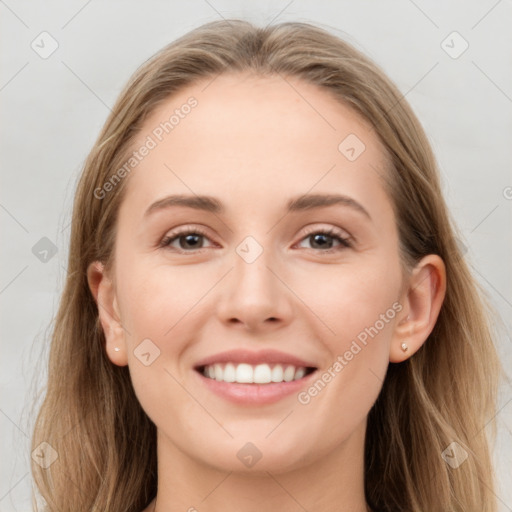 Joyful white young-adult female with long  brown hair and grey eyes