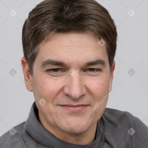 Joyful white adult male with short  brown hair and brown eyes